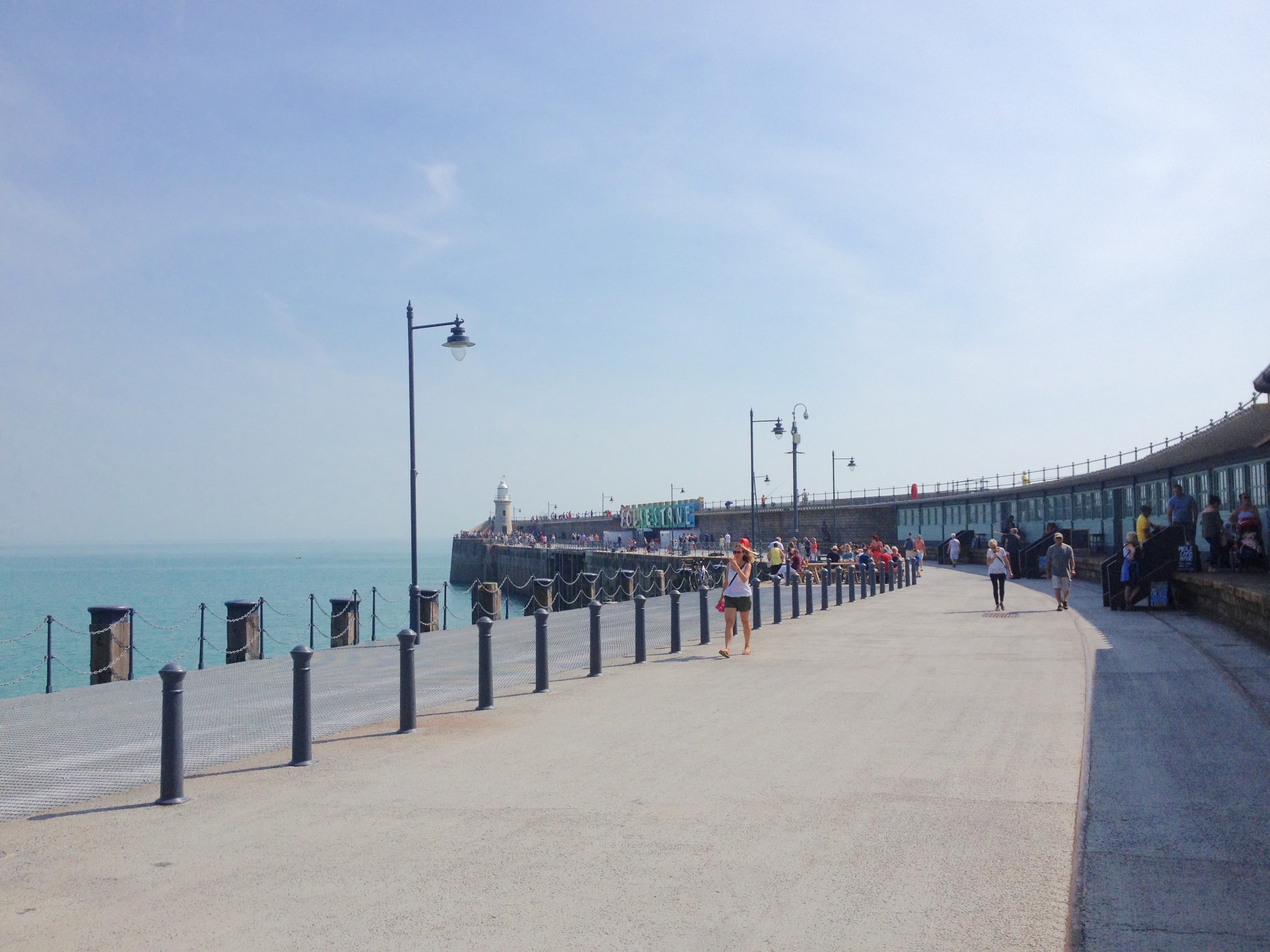 Folkestone Harbour Arm — the restored Victorian pier with the lighthouse and FOLKESTONE sign